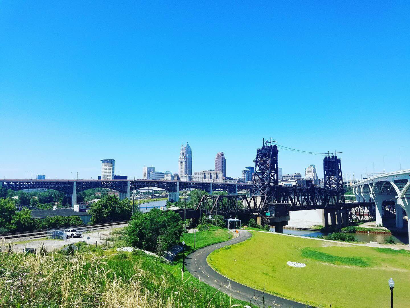 A view of downtown Cleveland from the Tremont neighborhood, overlooking greenery and the Ohio & Erie Canalway Towpath Trail.